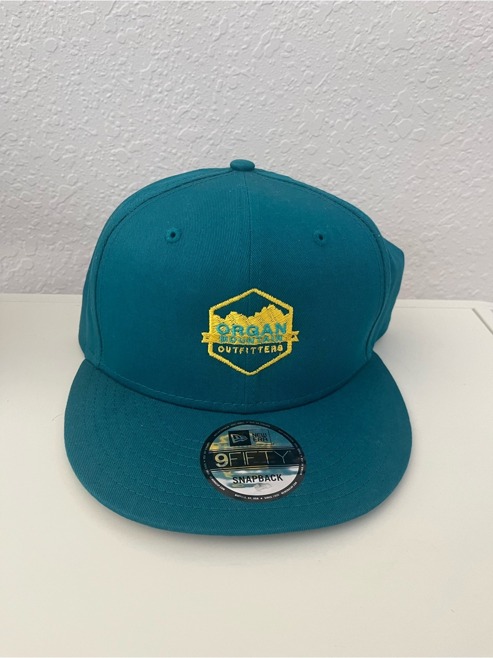 New Era Teal Snapback Hat with Yellow Embroidered Logo